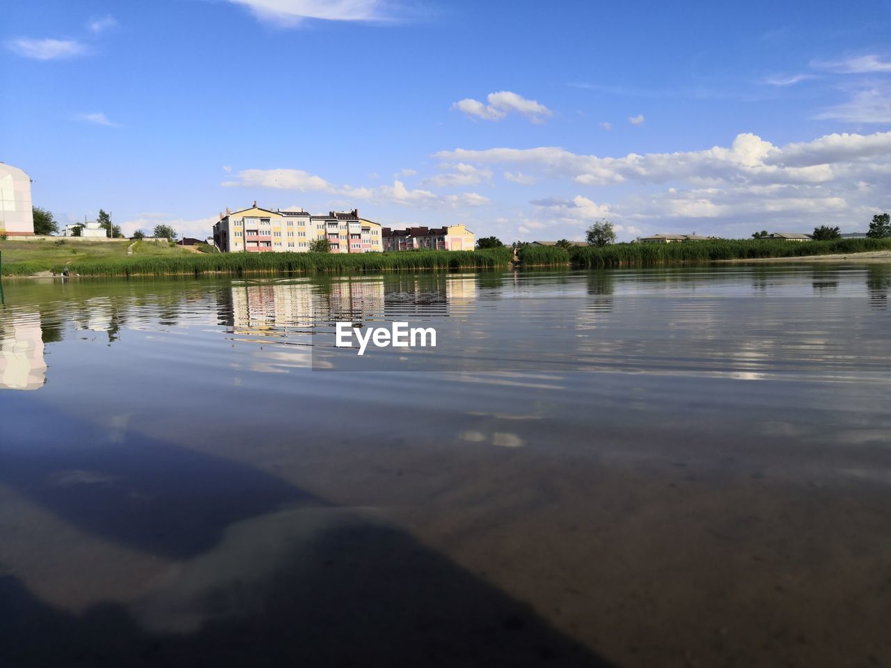 REFLECTION OF BUILDING ON LAKE