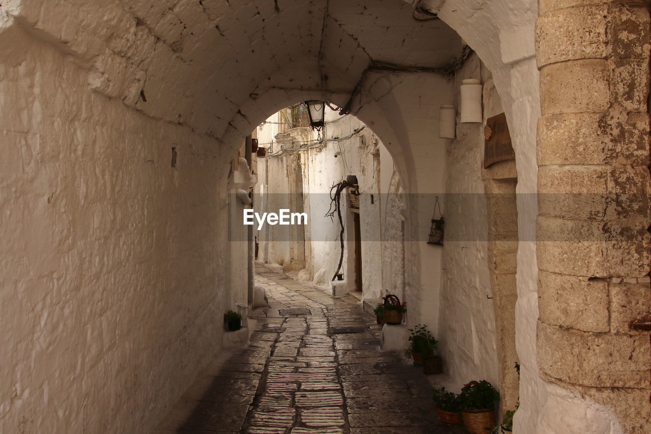 View trough an arch in the medival white village of ostuni, italy