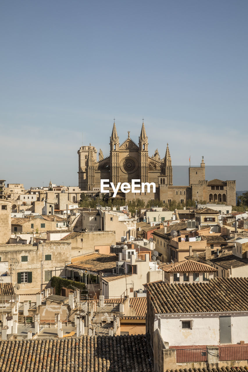 Spain, balearic islands, palma de mallorca, old town houses with palma cathedral in background