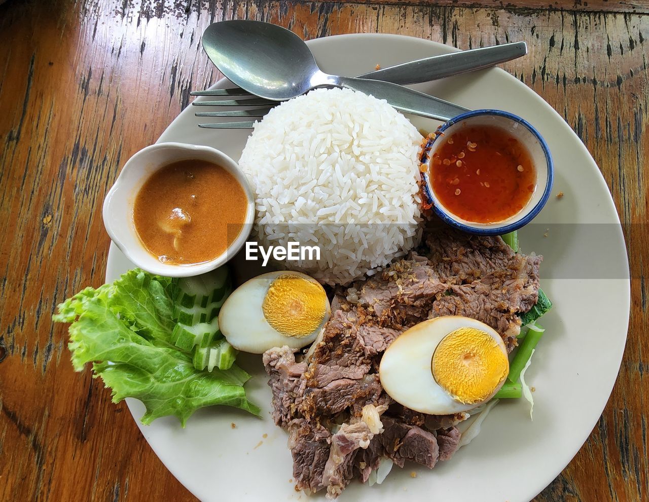 food, food and drink, healthy eating, meal, freshness, plate, vegetable, meat, wellbeing, table, fried, egg, dish, wood, high angle view, indoors, kitchen utensil, no people, cuisine, eating utensil, asian food, savory food, directly above, sauce, lunch, fried egg, bowl, nasi lemak, condiment, rice - food staple, egg yolk, breakfast, spoon, fruit