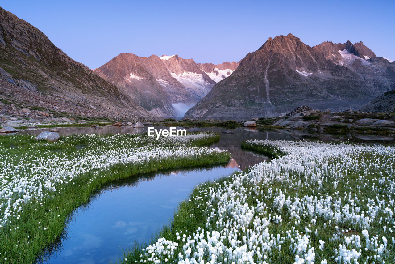 Scenic view of lake and mountains against clear sky