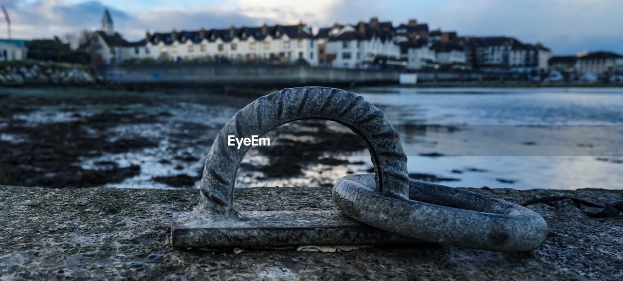 Close-up of metallic rings at beach