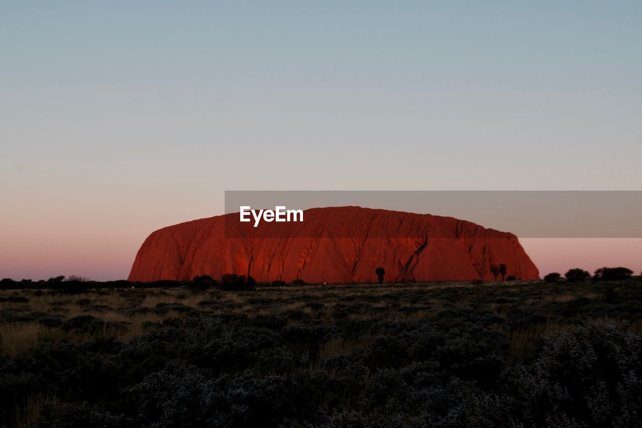 Scenic view of rock formation against sky during sunset