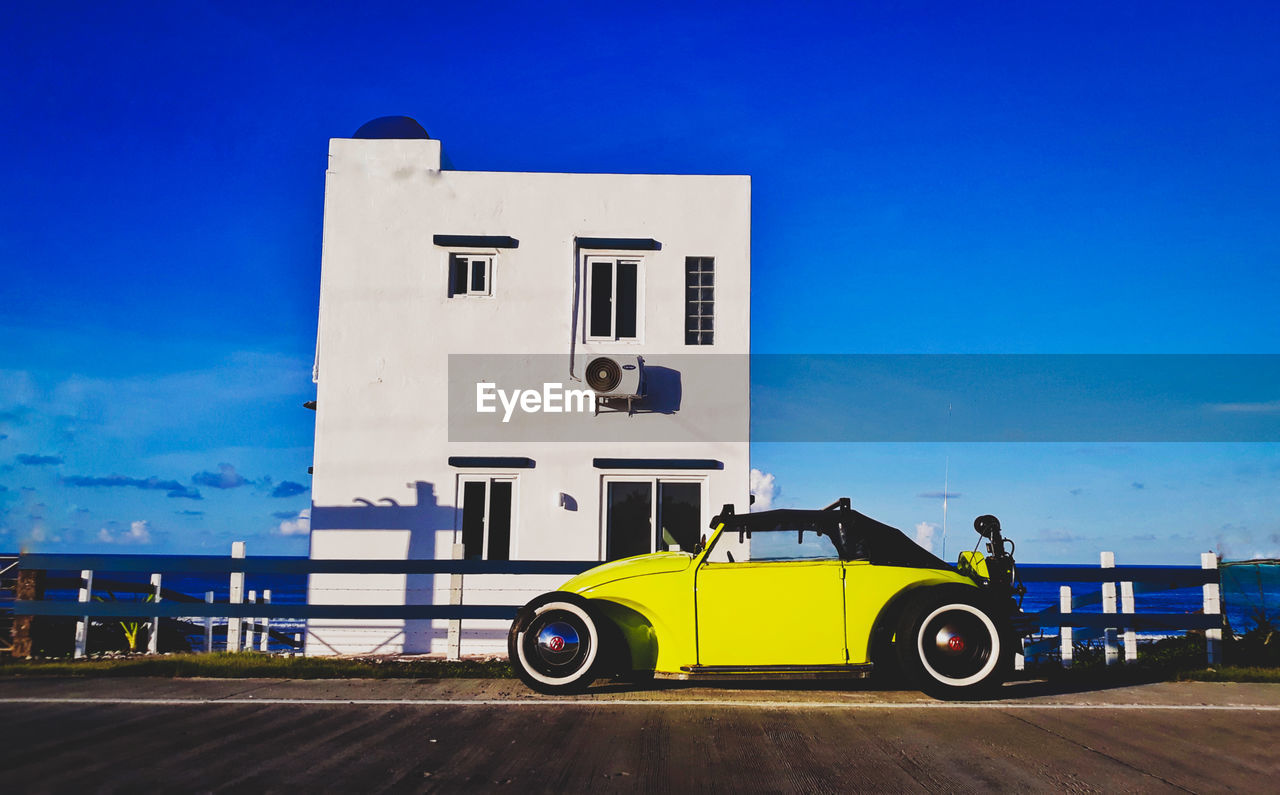 CAR ON ROAD AGAINST BLUE SKY