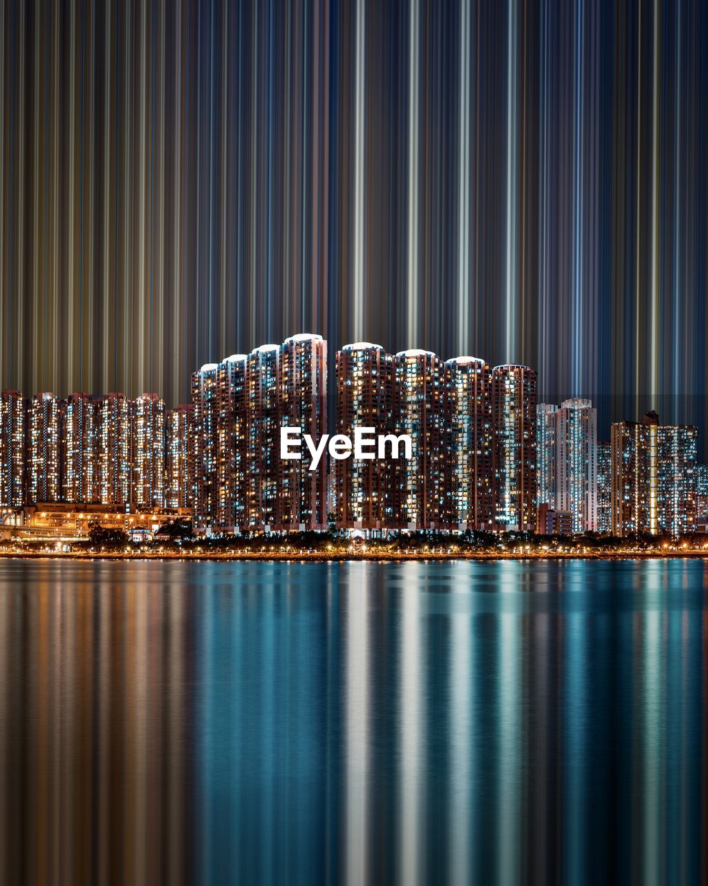 Illuminated modern building in city against sky at night