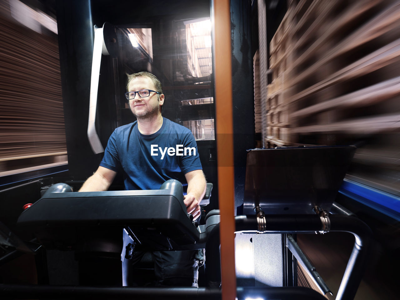 Worker using computer in automated factory