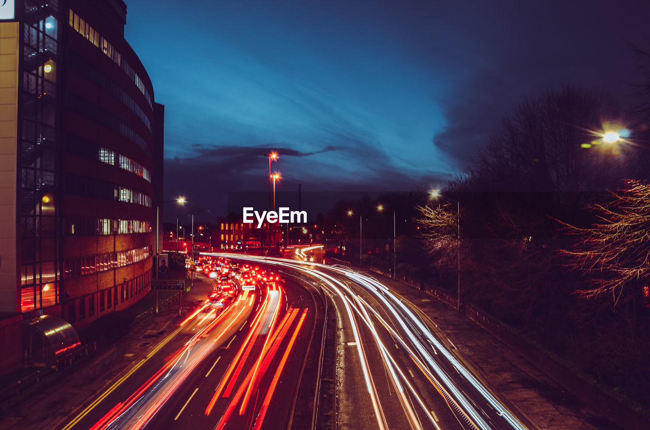 Light trails on road in city at night