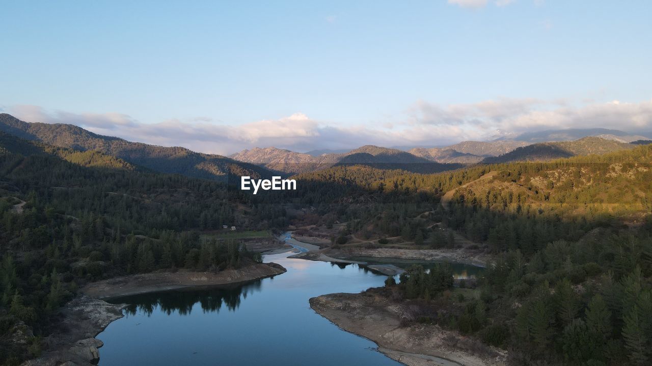 Scenic view of lake and mountains against sky
