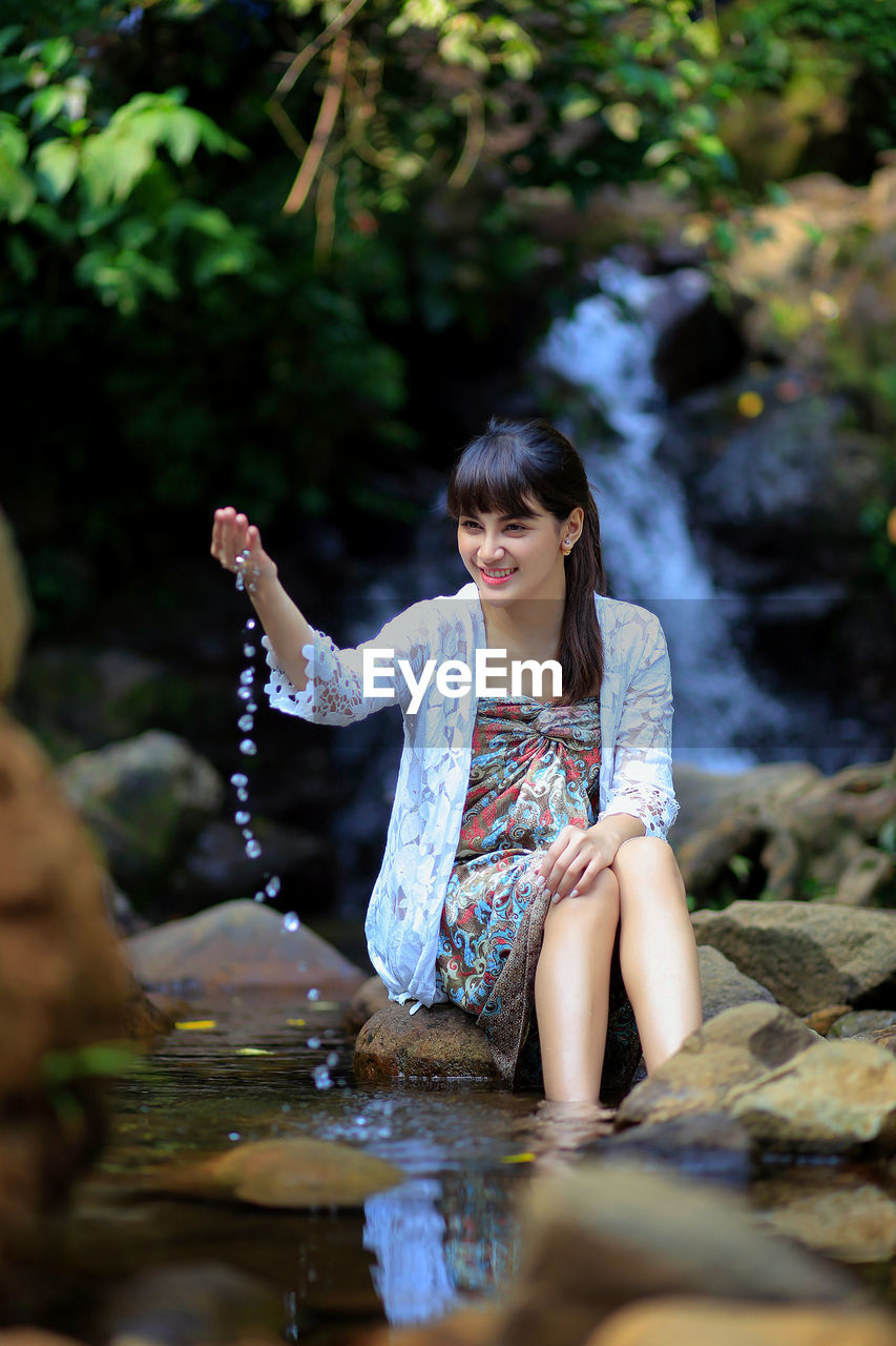 Woman sitting in water