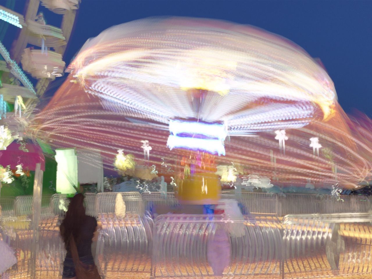 BLURRED MOTION OF PEOPLE IN CITY AT NIGHT