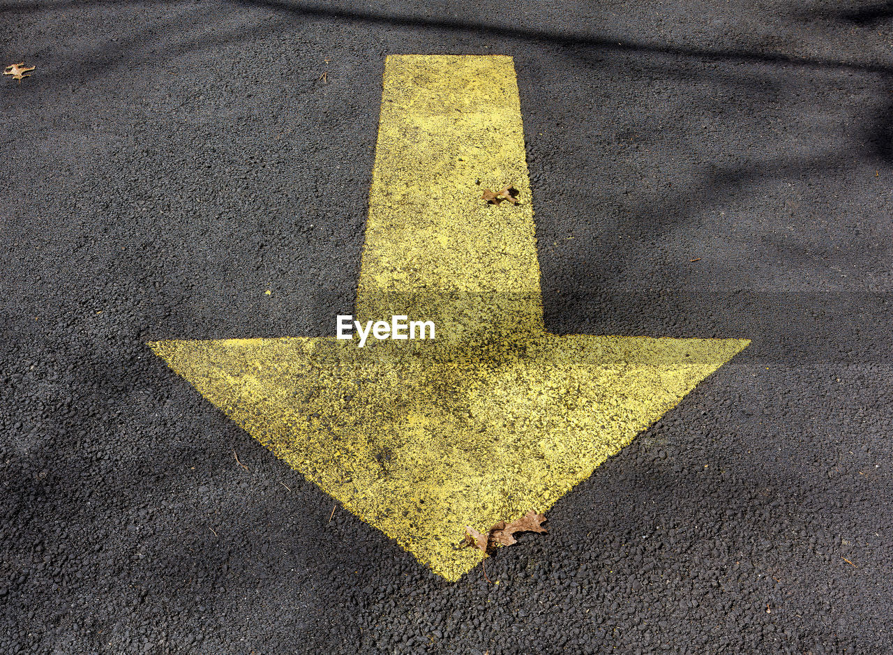 yellow, sign, symbol, road, transportation, communication, no people, road marking, high angle view, marking, asphalt, arrow symbol, leaf, guidance, green, street, city, day, directional sign, close-up, outdoors, line