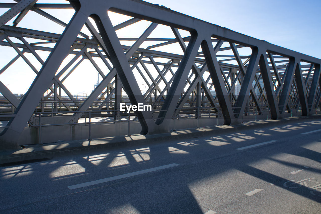 LOW ANGLE VIEW OF METALLIC BRIDGE AGAINST SKY