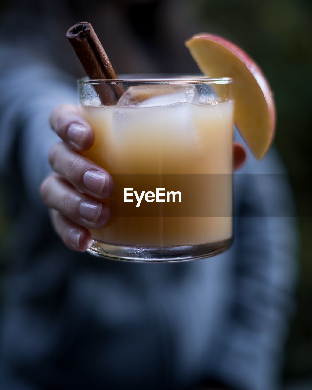 Close-up of hand holding juice in glass