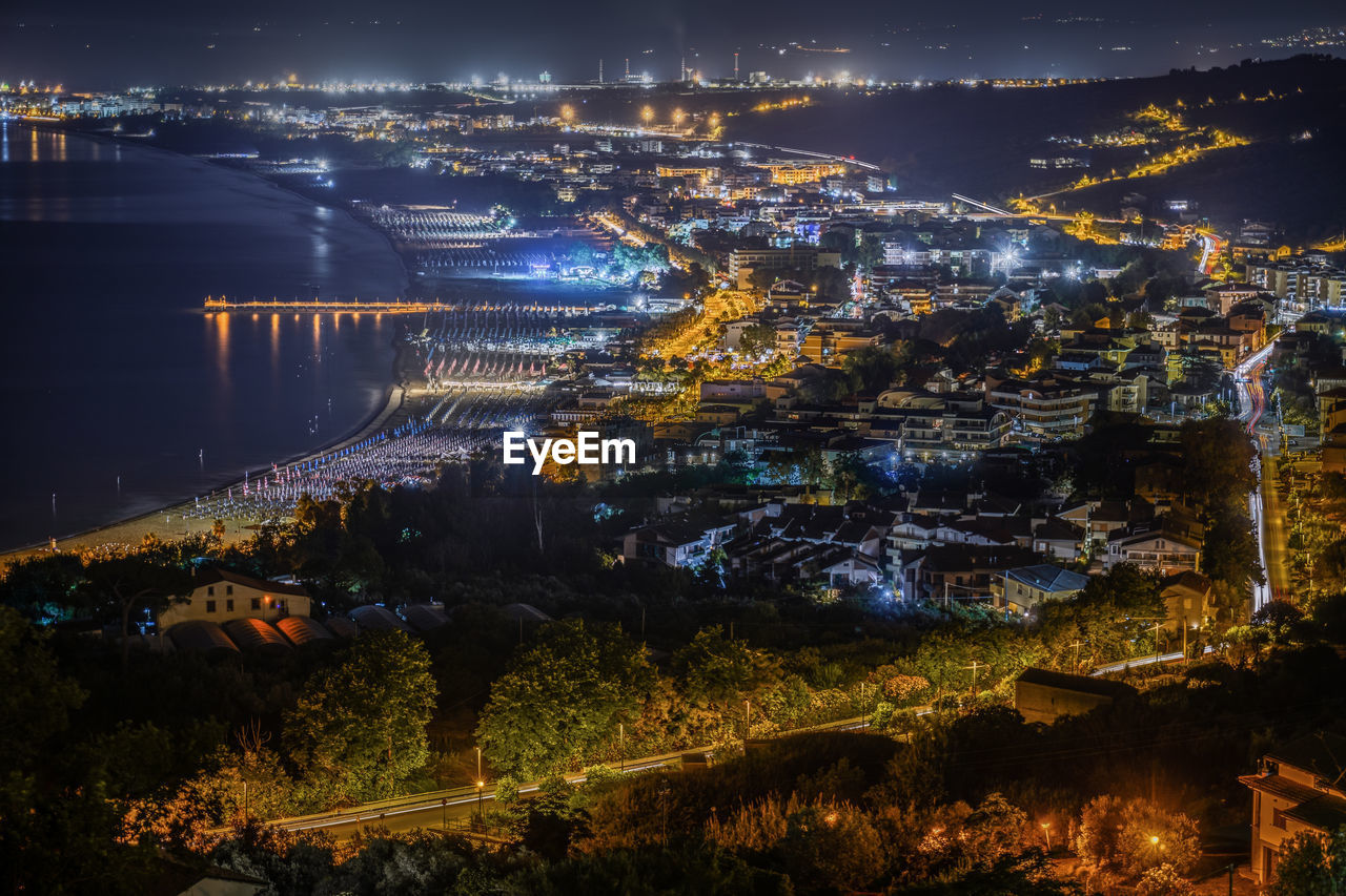 HIGH ANGLE VIEW OF ILLUMINATED BUILDINGS IN CITY