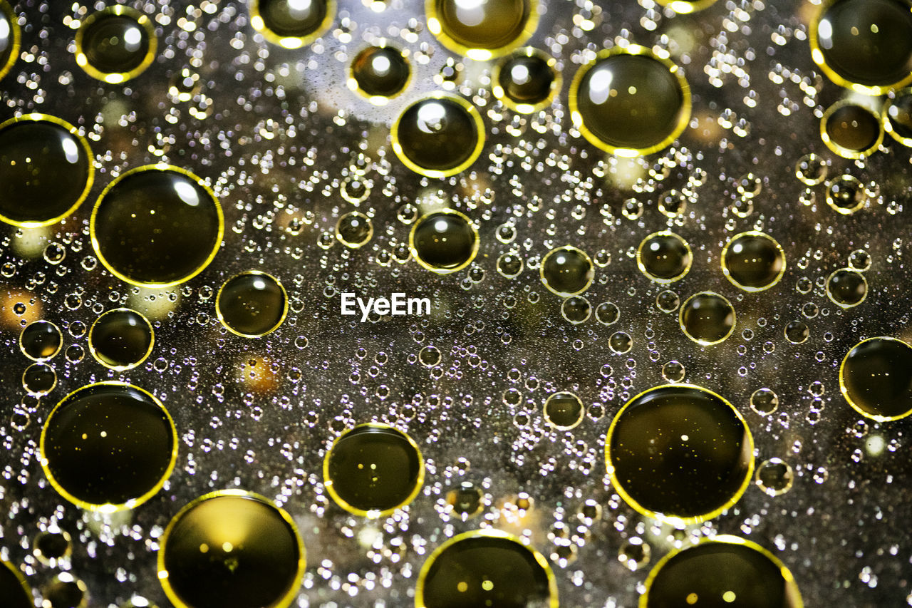 FULL FRAME SHOT OF WATER DROPS ON GLASS