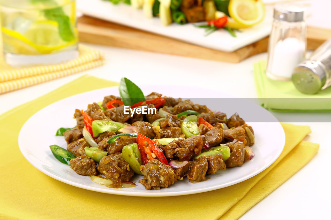 Close-up of oseng daging in plate on restaurant