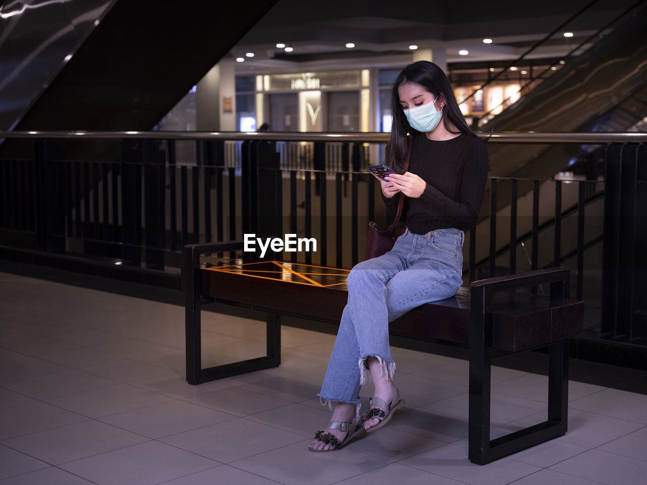 Woman sitting on railing