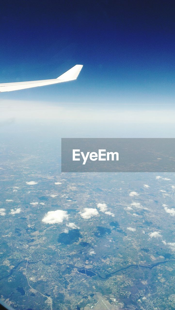 Aerial view of landscape and airplane wing