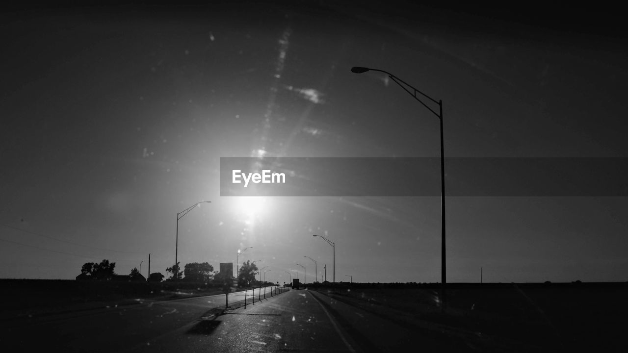 CARS ON ROAD AGAINST SKY