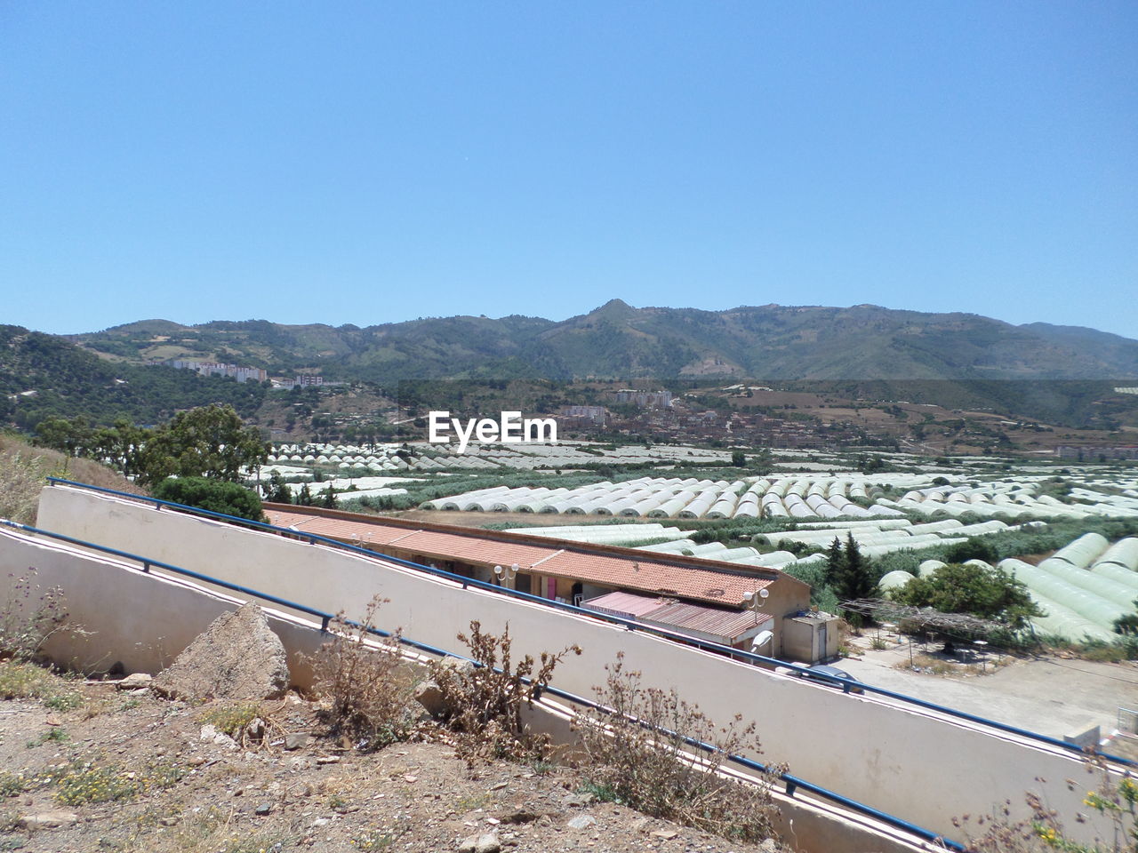 HIGH ANGLE VIEW OF ROAD AGAINST CLEAR BLUE SKY