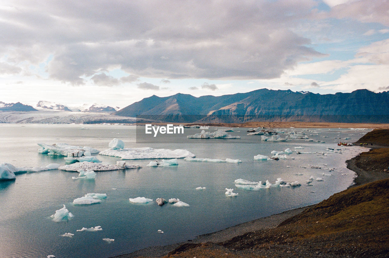 Scenic view of glacial lagoon against sky