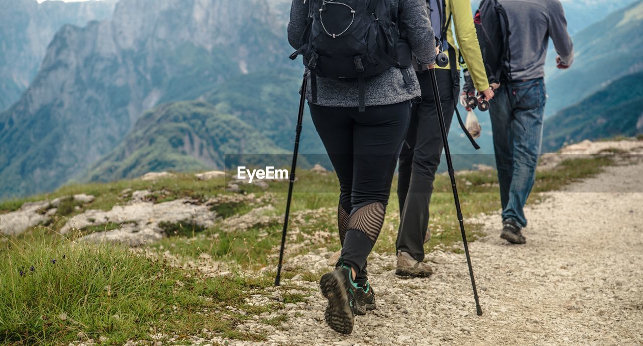 Low section of hikers walking on cliff