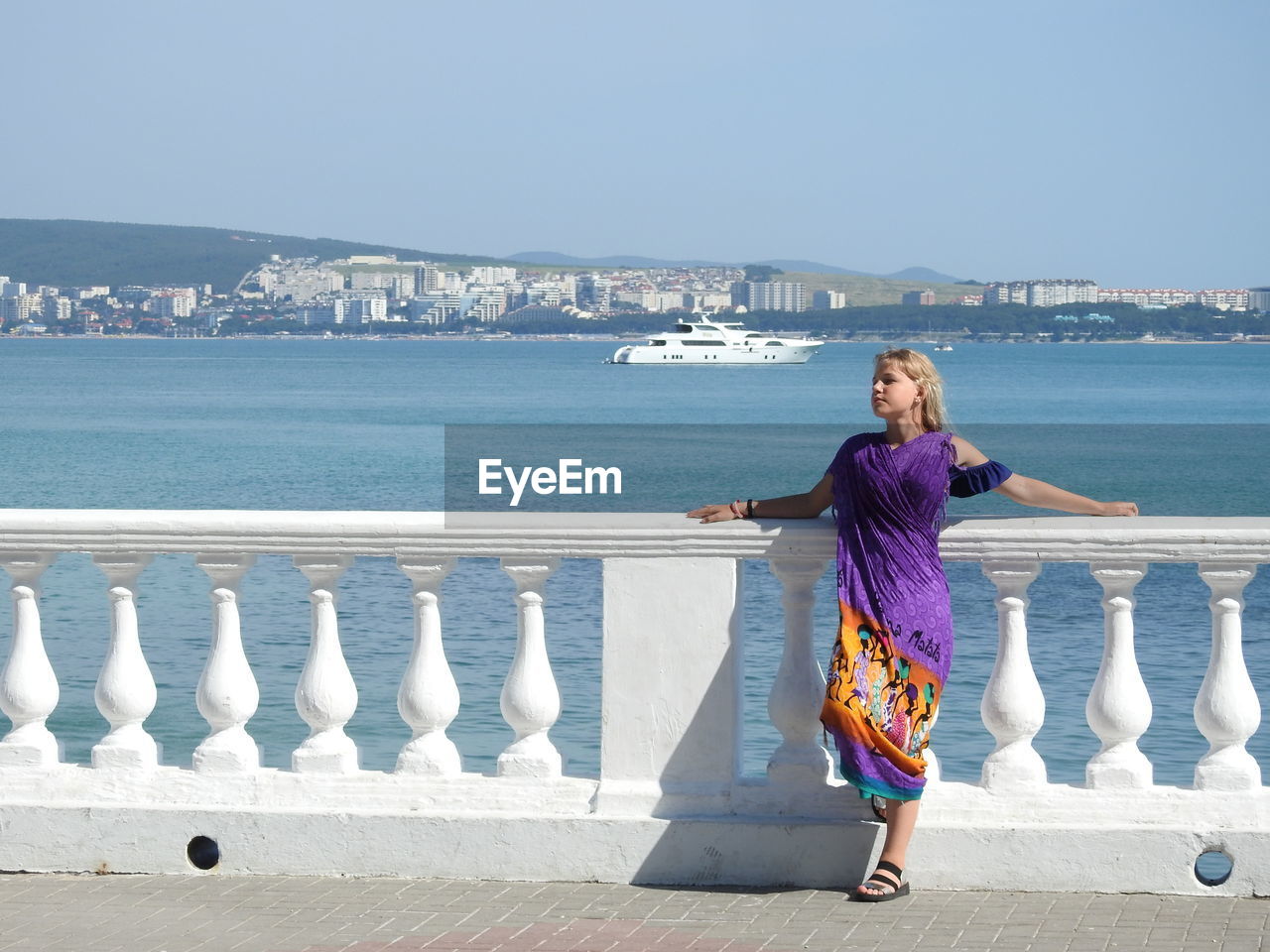 Girl looking away against sea