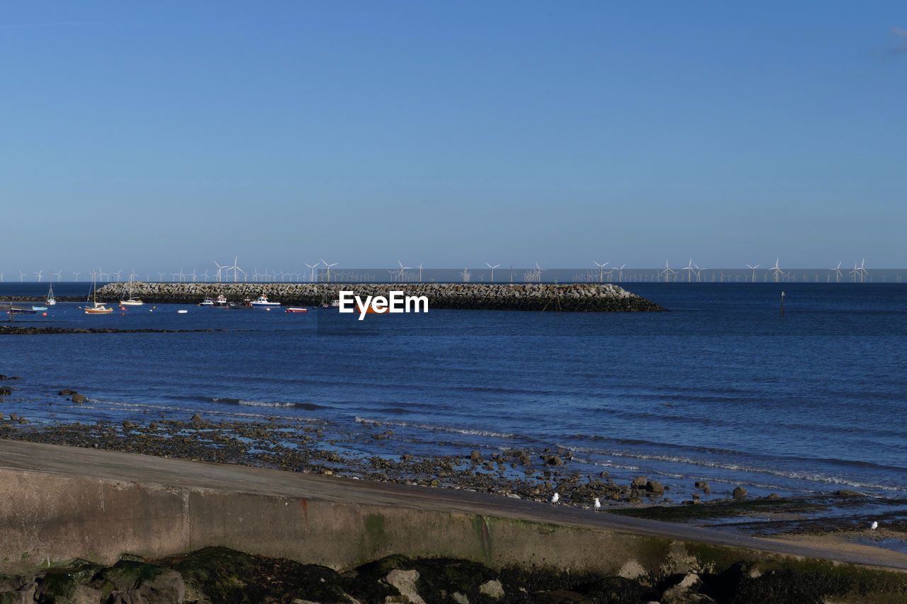 Scenic view of sea against clear blue sky