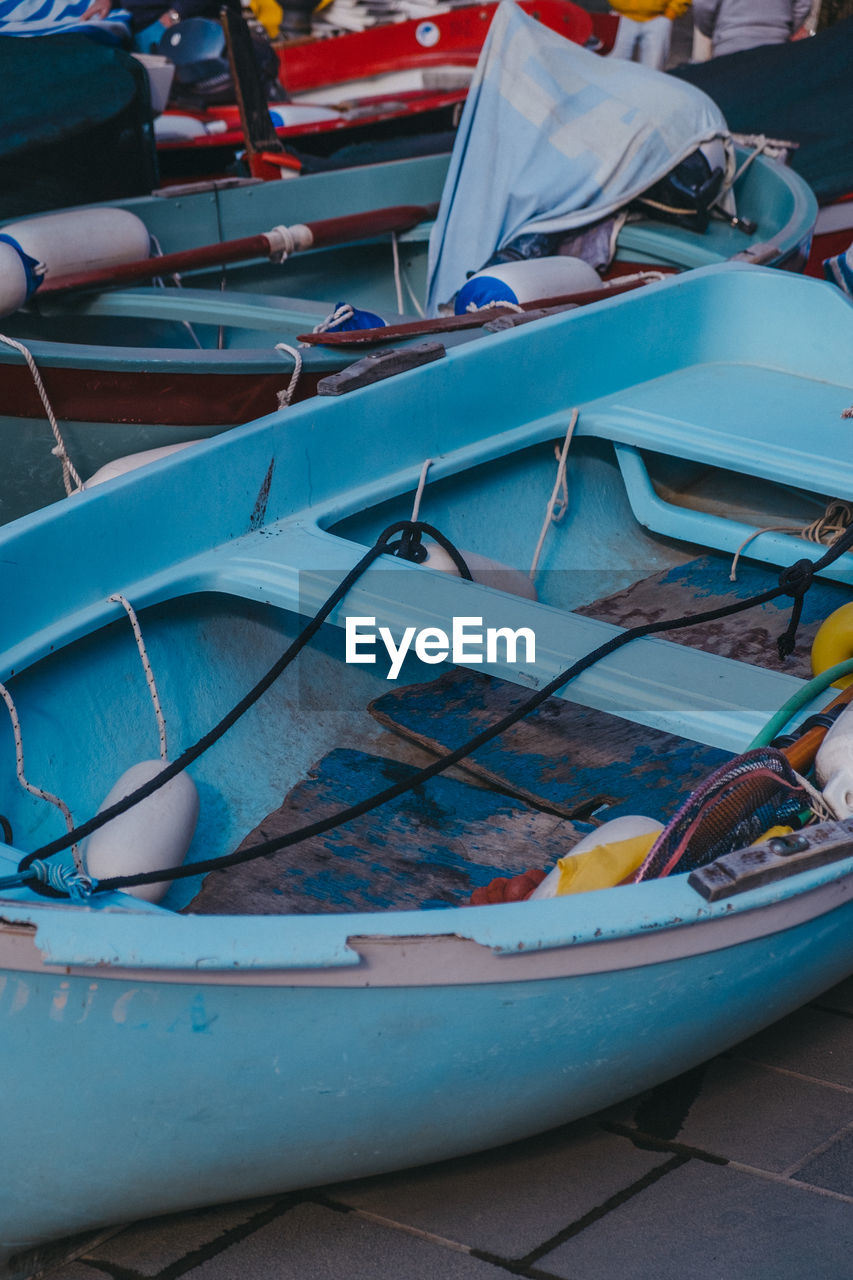 CLOSE-UP OF BOATS MOORED ON BEACH