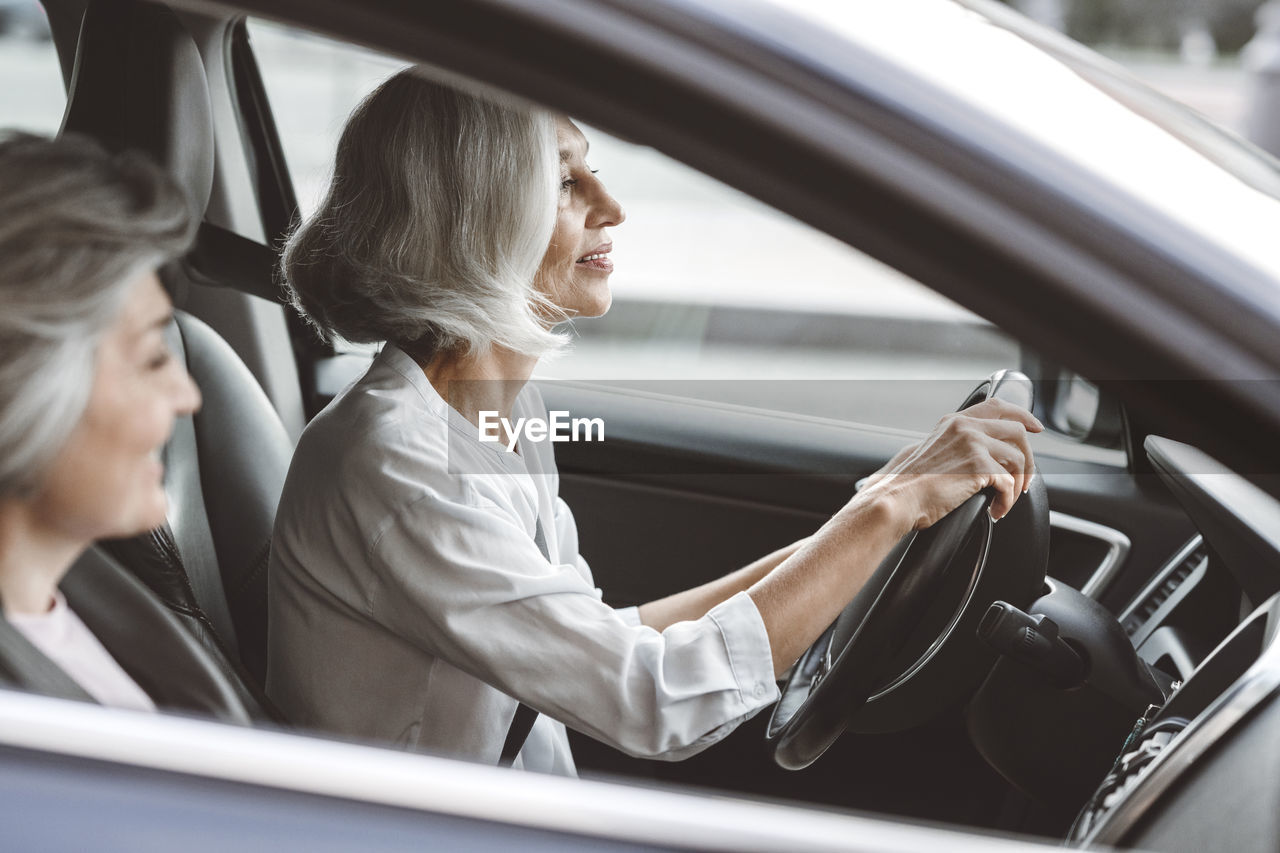 Smiling businesswomen traveling together in car