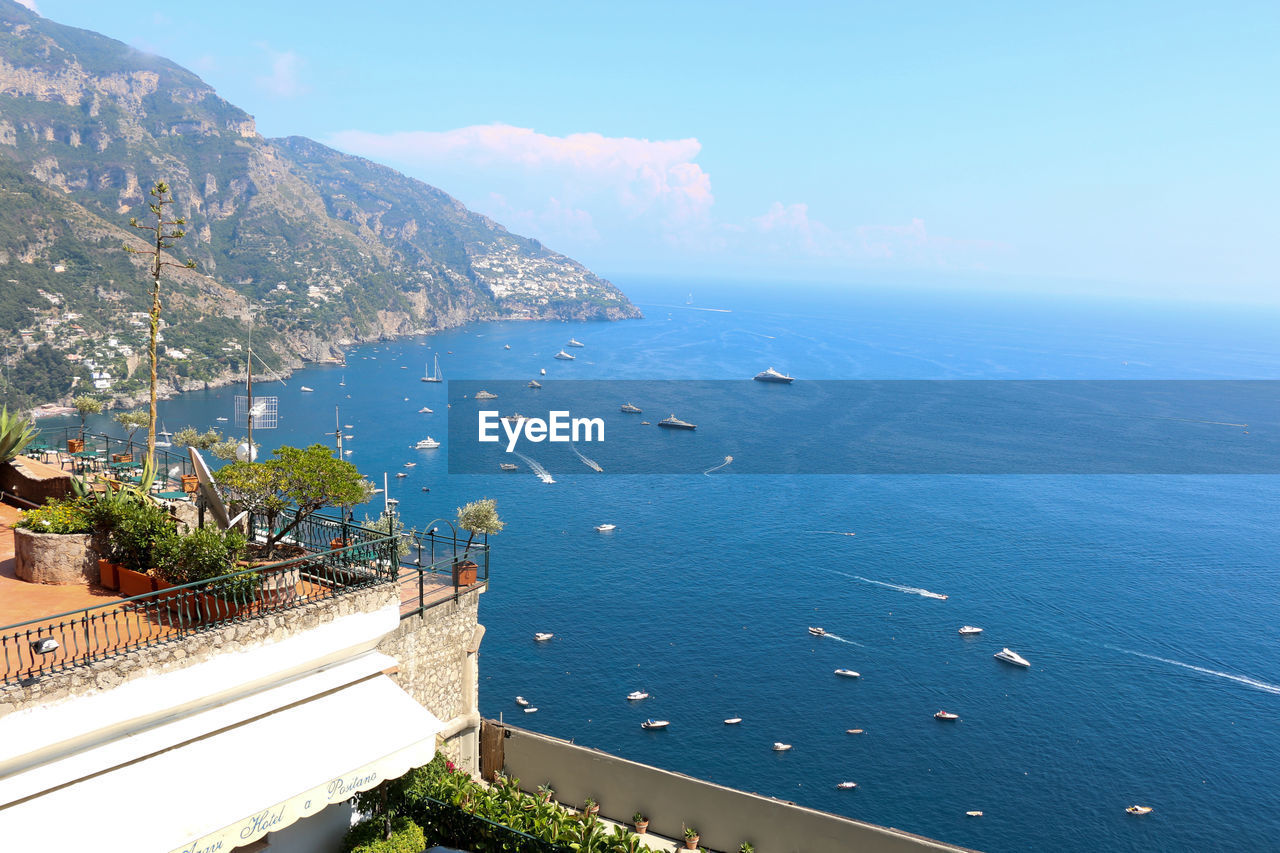 High angle view of sea and buildings against sky