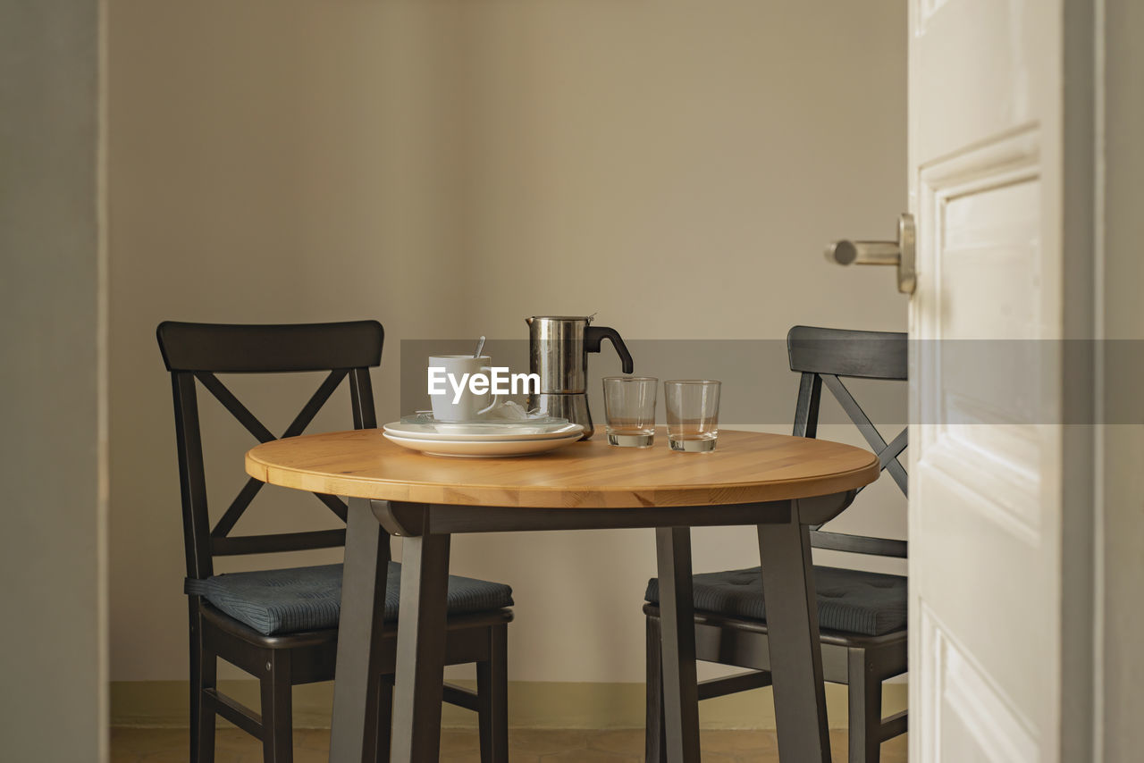 EMPTY CHAIRS AND TABLE AT RESTAURANT