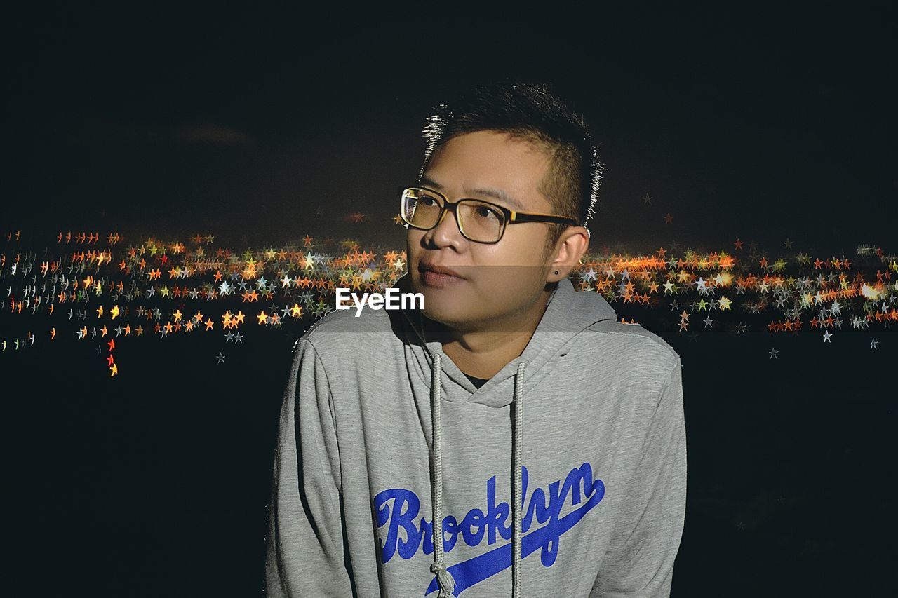 PORTRAIT OF YOUNG MAN WITH EYEGLASSES