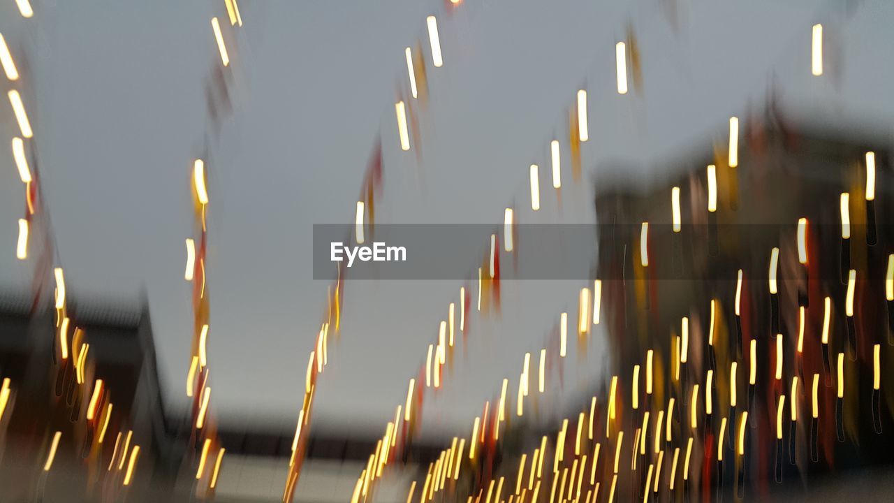 LOW ANGLE VIEW OF ILLUMINATED DECORATIONS