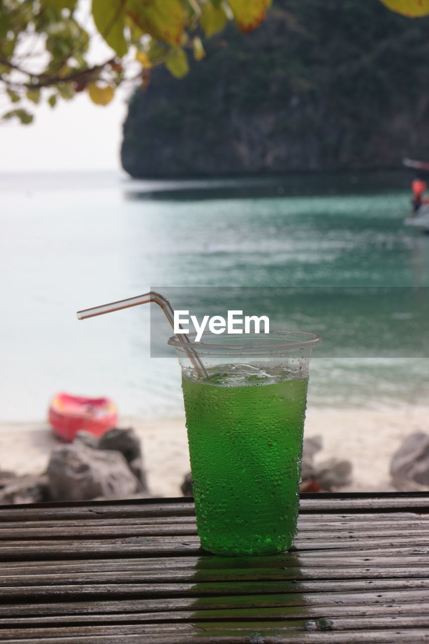 green, hanging, day, focus on foreground, nature, no people, window, outdoors, yellow, plant, glass, close-up, water, leaf