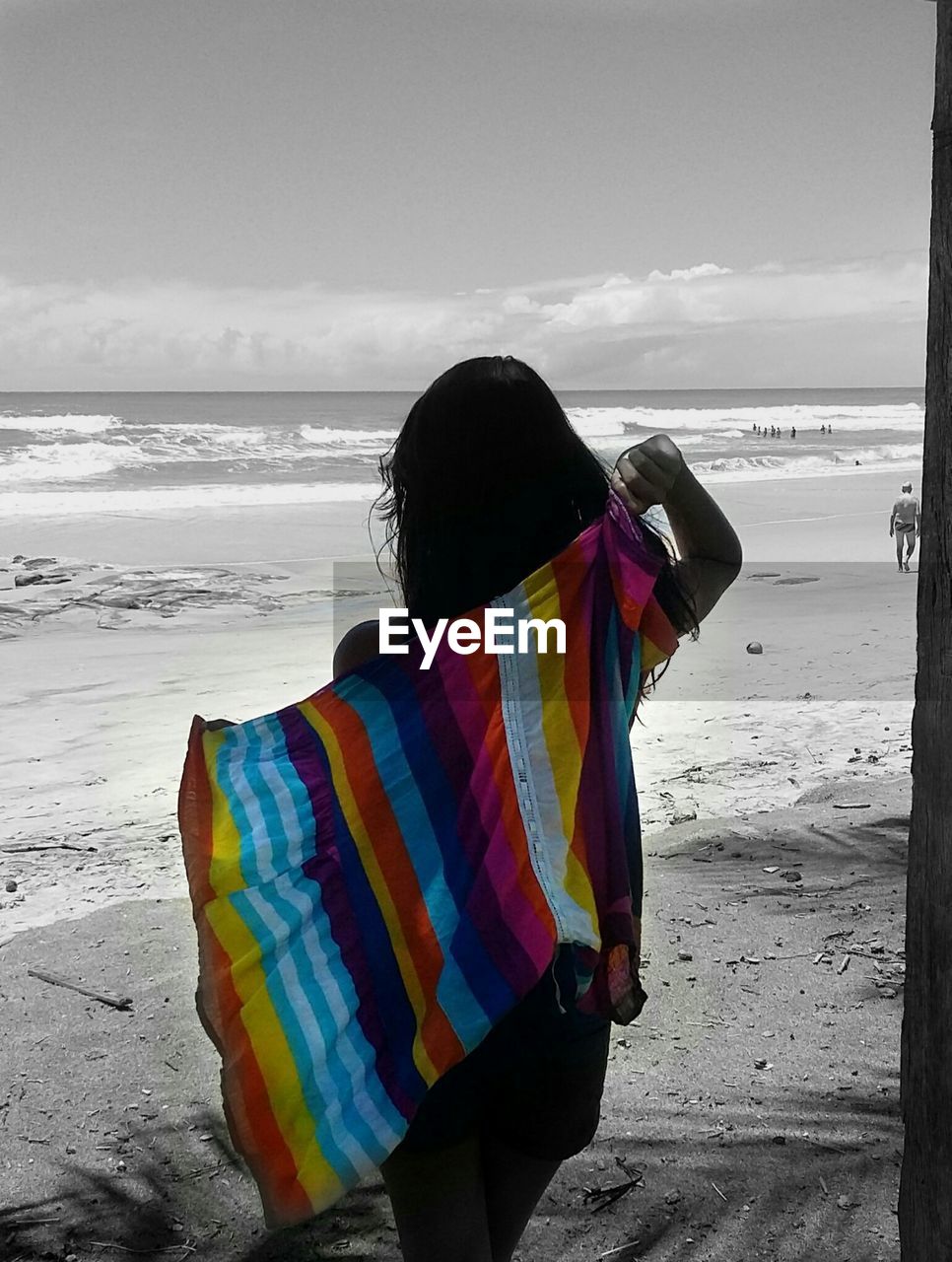 Rear view of woman overlooking calm sea