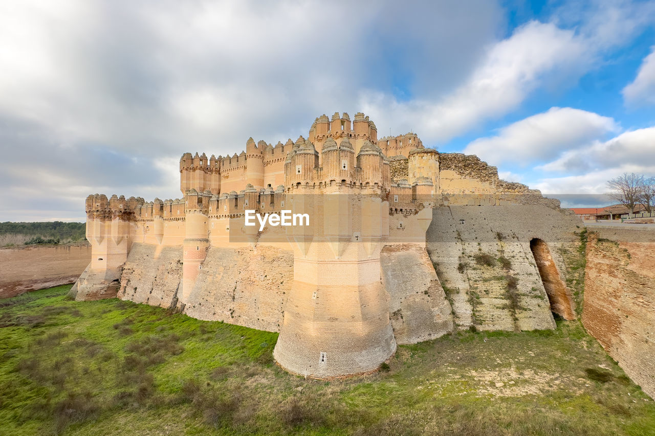 history, the past, sky, architecture, travel destinations, cloud, ancient, fortification, ruins, travel, nature, historic site, land, built structure, old ruin, ancient history, tourism, castle, landscape, no people, rock, fort, outdoors, environment, terrain, archaeological site, landmark, scenics - nature, plant, ancient civilization, stone material, archaeology, old, building, grass, day, building exterior, wall, monument, memorial, cliff