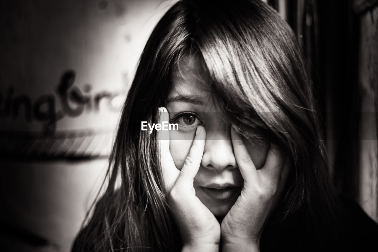 PORTRAIT OF YOUNG WOMAN WITH EYES HAIR