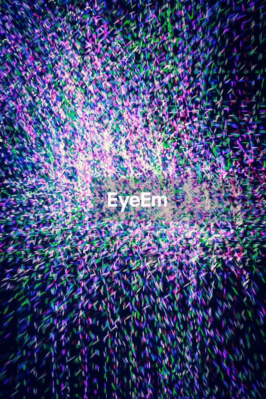 DEFOCUSED IMAGE OF MULTI COLORED LIGHTS