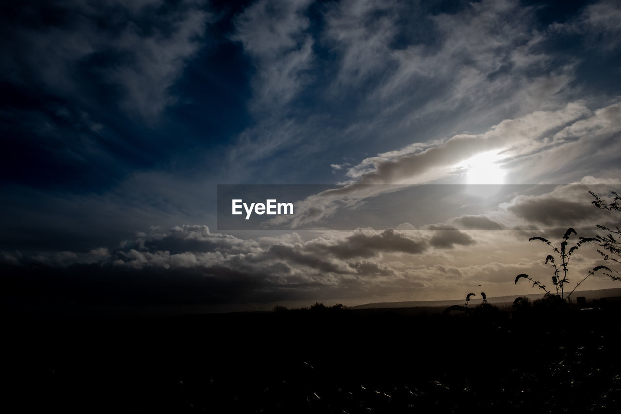 SCENIC VIEW OF SILHOUETTE LANDSCAPE AGAINST SUNSET SKY