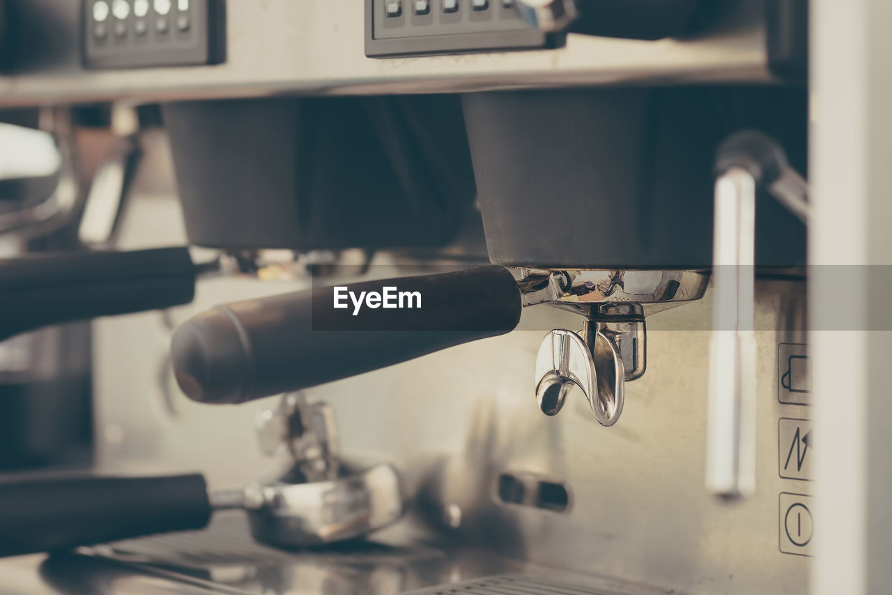 CLOSE-UP OF COFFEE CUP OF MACHINE