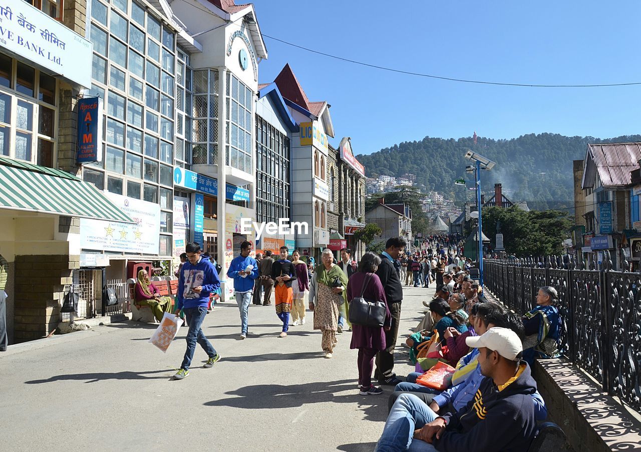 PEOPLE WALKING ON STREET IN CITY