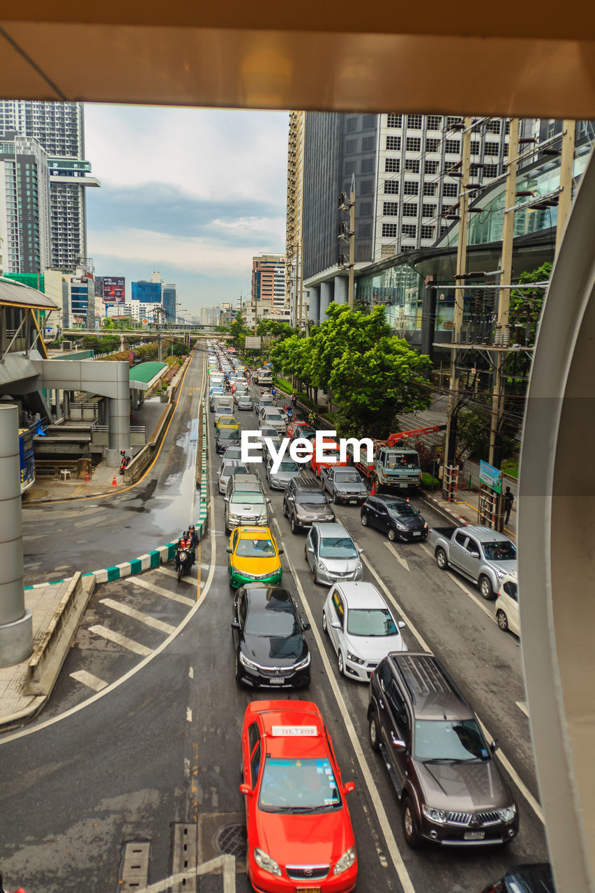 High angle view of traffic on road amidst buildings in city