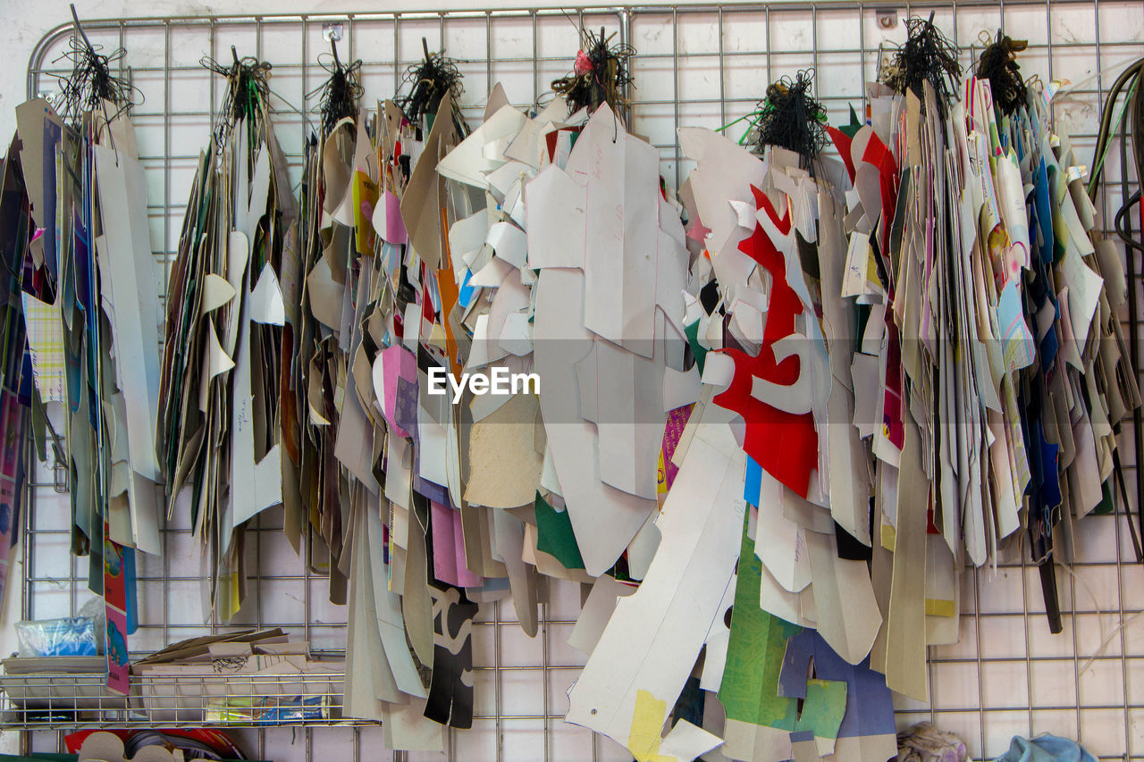 LOW ANGLE VIEW OF CLOTHES DRYING AGAINST WALL