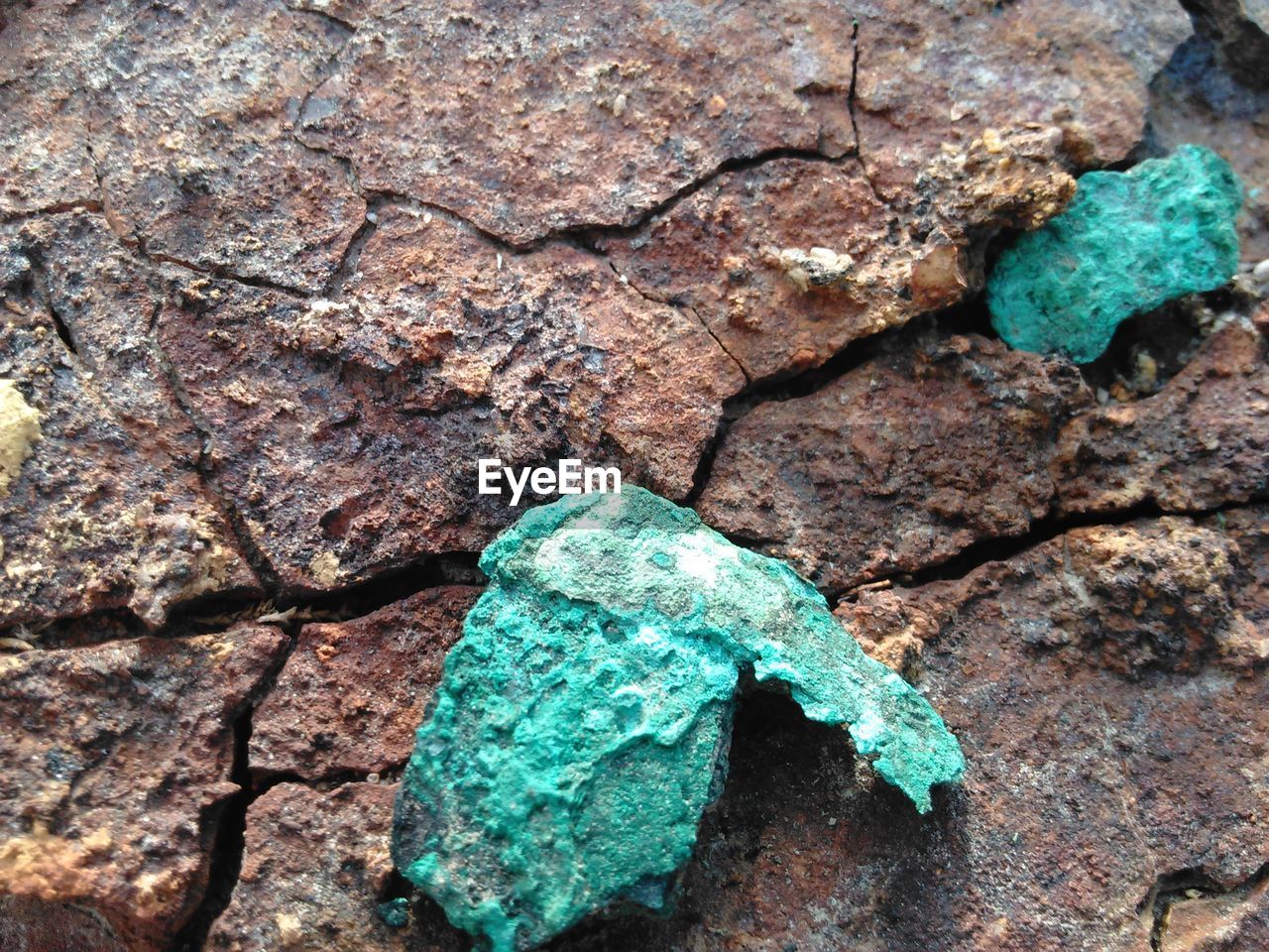 CLOSE-UP OF ROCKS AGAINST BLUE SKY