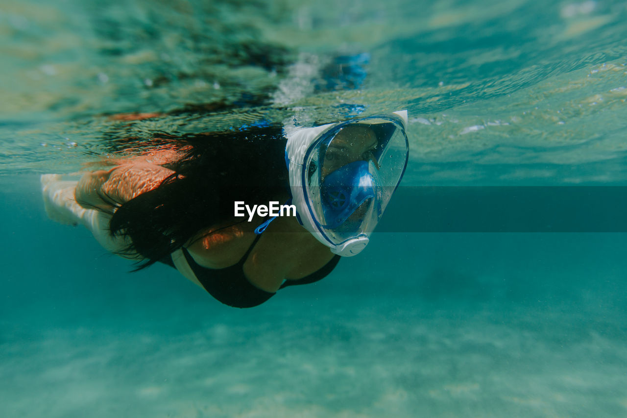 Full length of woman diving in sea