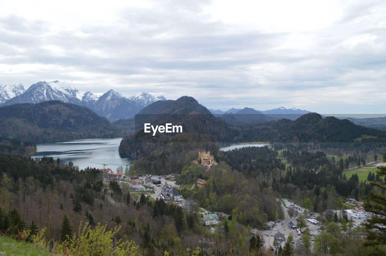 Scenic view of river and mountains against sky