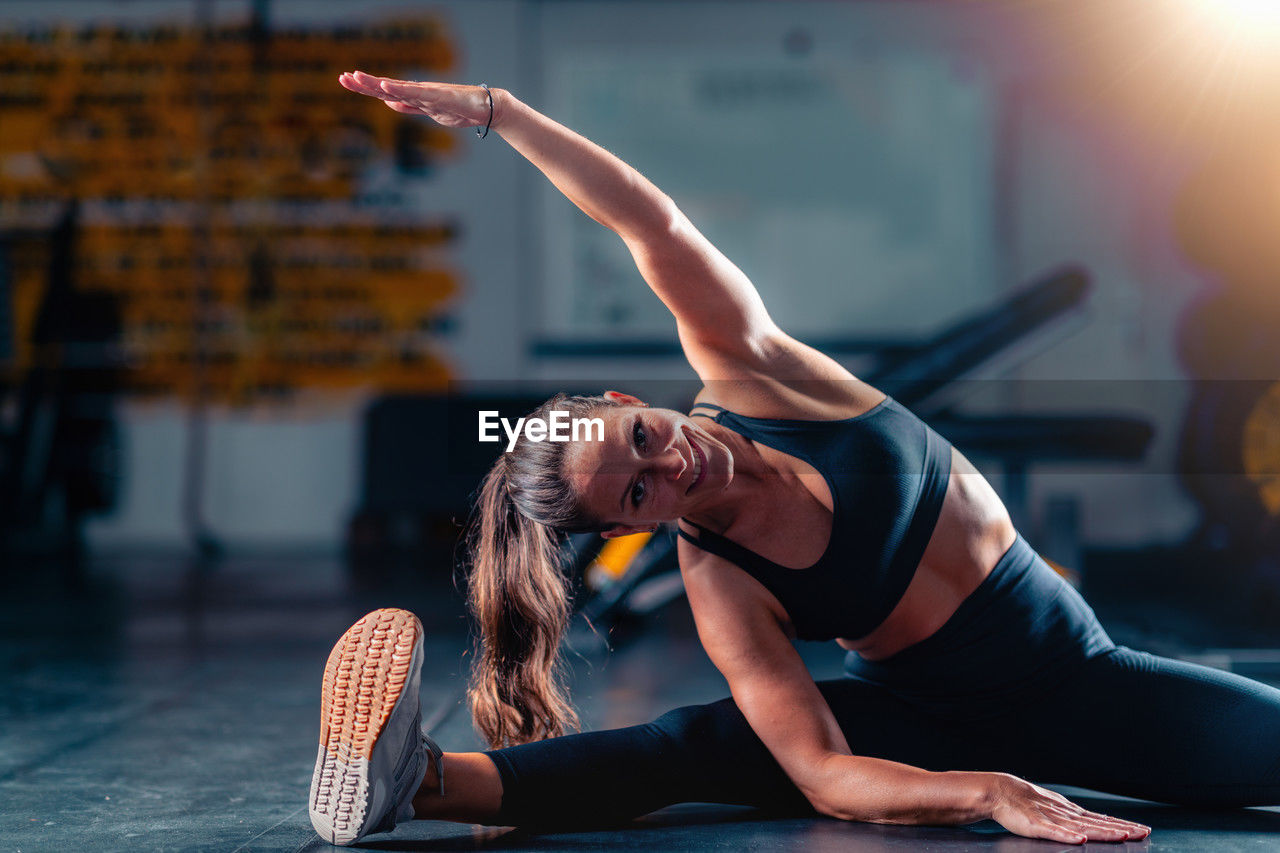 portrait of young woman doing yoga at park