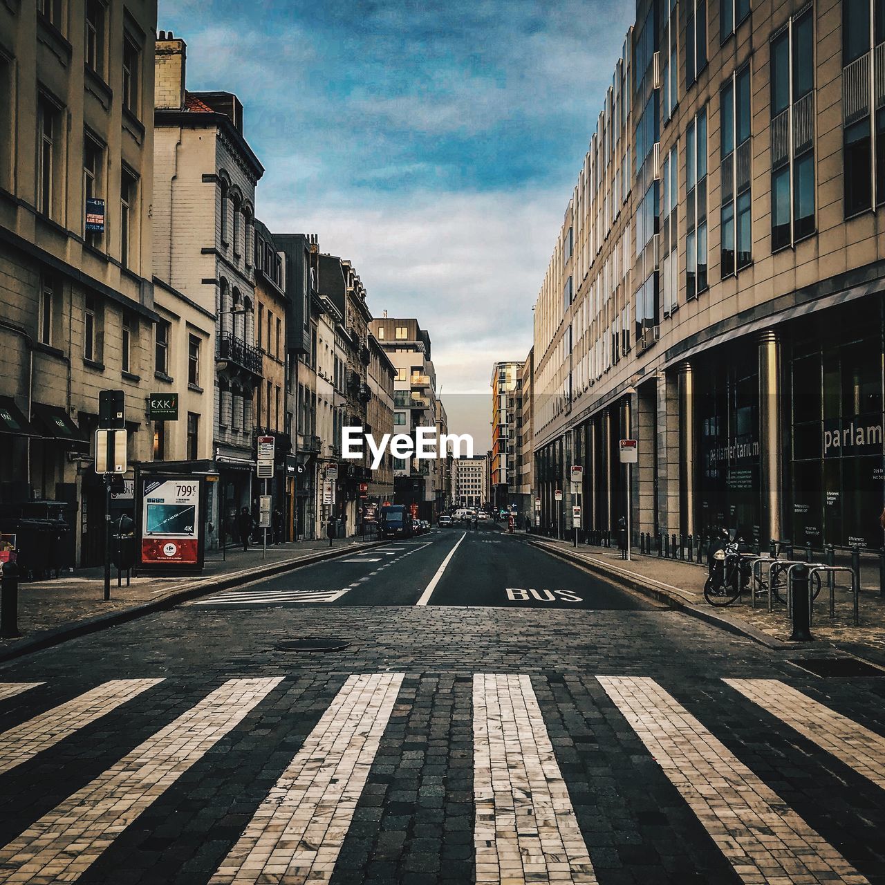 Street amidst buildings in city against sky