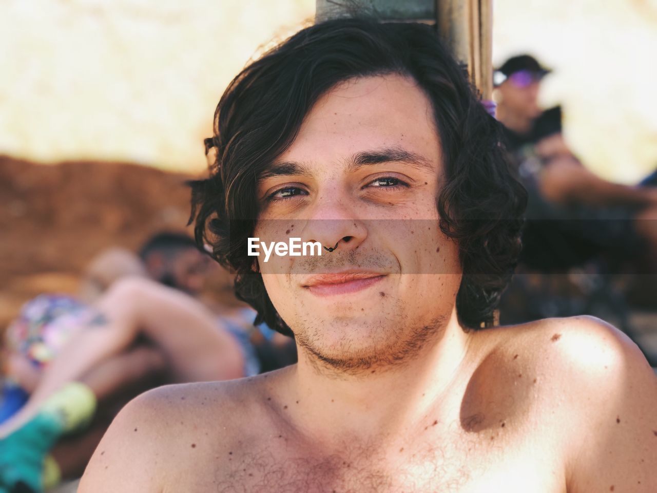 Close-up portrait of shirtless man in sunny day